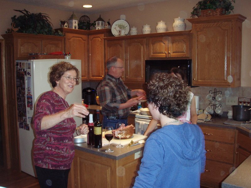 Linda and Whitney share a story, while Ray cooks dinner.