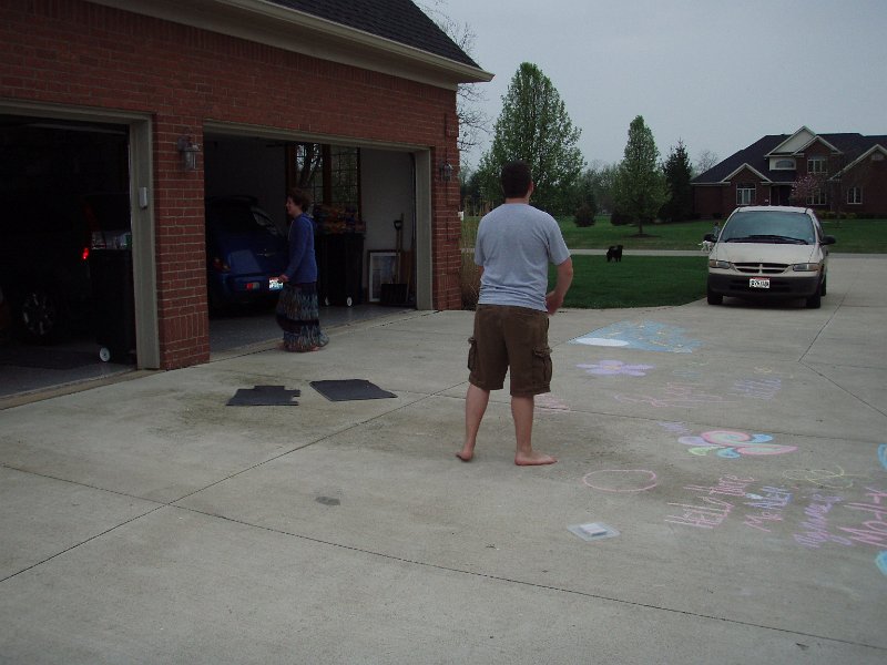 The twins, Whitney and Ryan, play ball in the driveway.