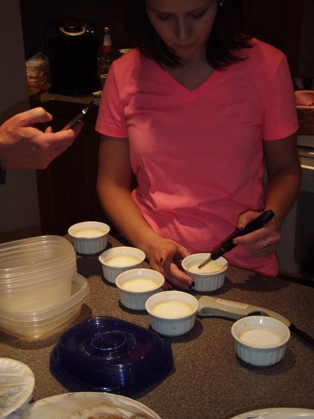Molly prepares the flan .... a tedious process of melting the sugar coating.
